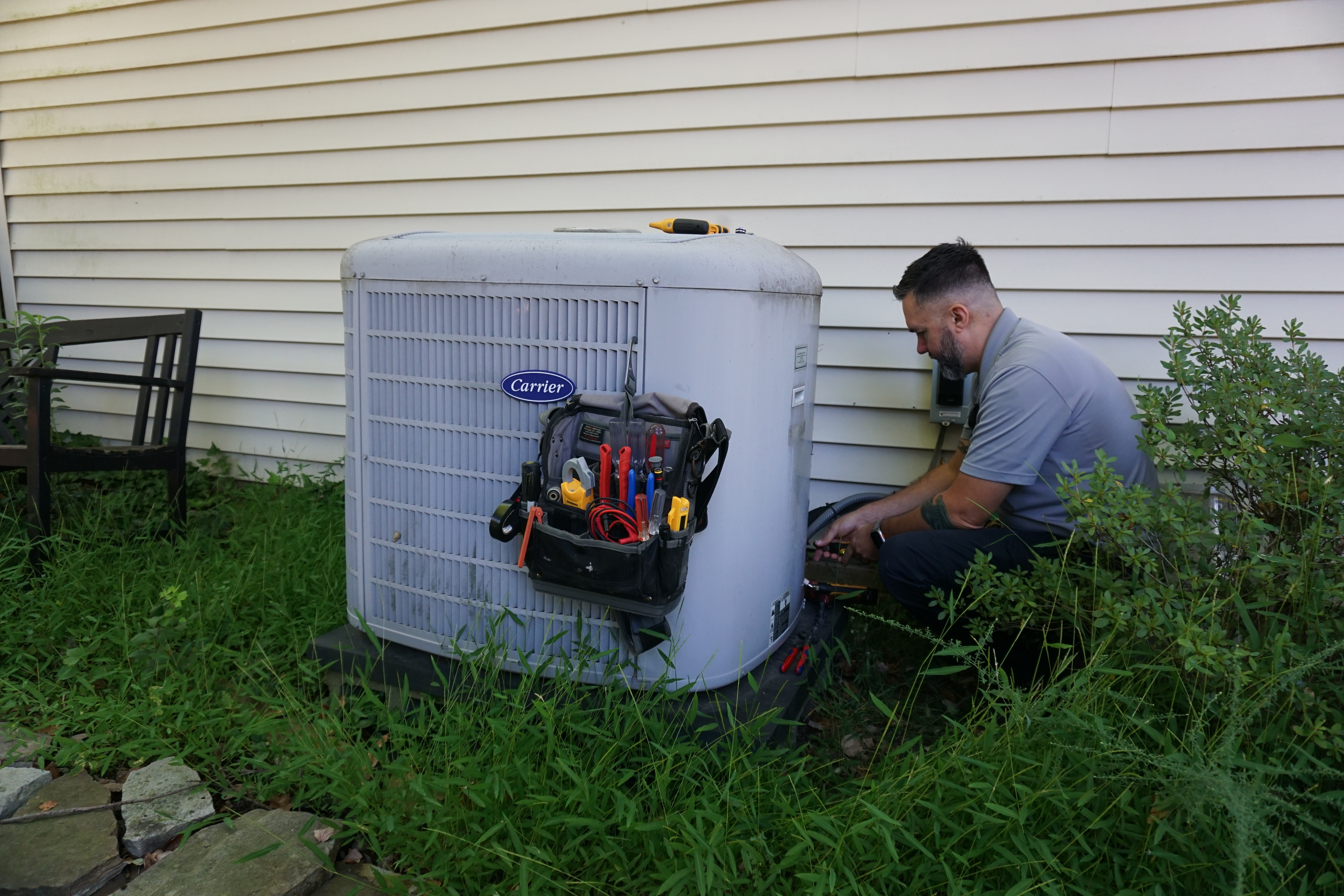 technician doing maintenance on HVAC system